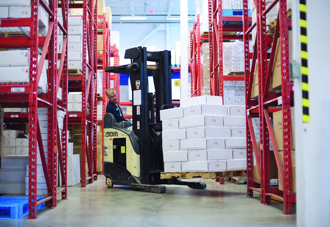 Worker operating a forklift in a warehouse